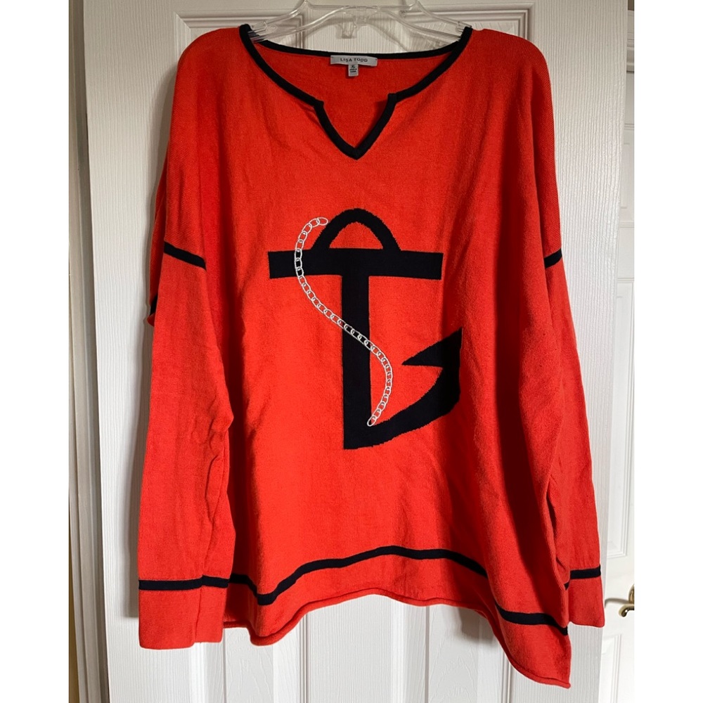 Lisa Todd orange and navy blue sweater